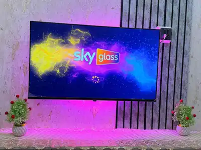Sky Glass IPTV splash screen on a wall-mounted television
